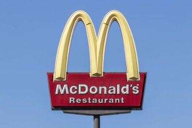 Brownsburg - Circa March 2022: McDonald's Restaurant. McDonald's is offering employees higher hourly wages, paid time off, backup child care and tuition payments. clipart