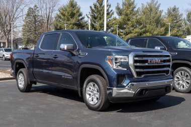 Kokomo - Nisan 2022: GMC Sierra AT4 ve Denali bir galeride sergileniyor. GMC Sierra 1500 çeşitli modeller ve dış paketlerde mevcuttur..