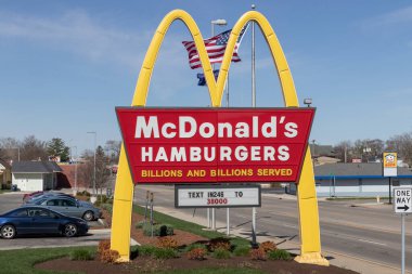 Richmond - Circa April 2022: McDonald's Restaurant. McDonald's is offering employees higher hourly wages, paid time off, backup child care and tuition payments. clipart