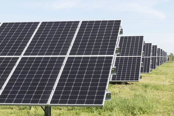 Solar panels and solar electricity farm. Many companies are converting unused land into solar farms to reduce their environmental impact on the planet.