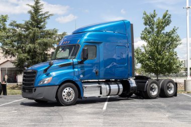 Indianapolis - Circa July 2022: Freightliner Semi Tractor Trailer Trucks Lined up for sale. Freightliner is owned by Daimler.