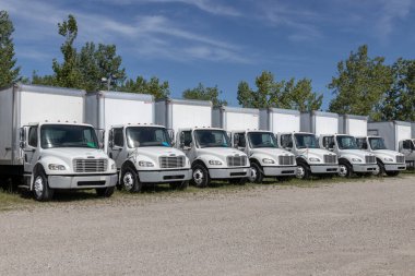 Indianapolis - Circa July 2022: Freightliner Semi Tractor Trailer Trucks Lined up for sale. Freightliner is owned by Daimler. clipart