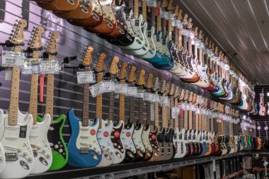Muncie - Circa August 2022: Fender Stratocaster guitar display at a music store. Strats are world renowned for their distinctive clean sound.