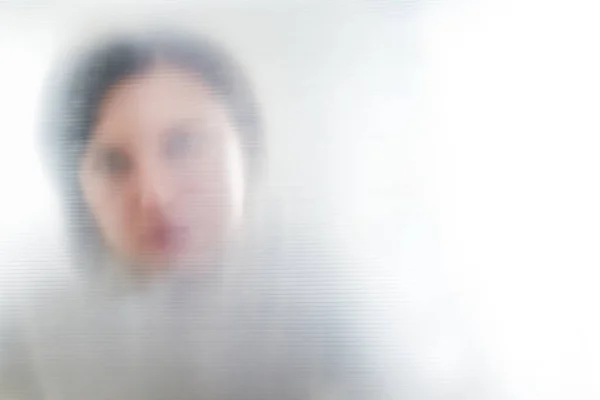 Silhouet van wazige eenzame vrouw die door doorzichtig plastic kijkt — Stockfoto