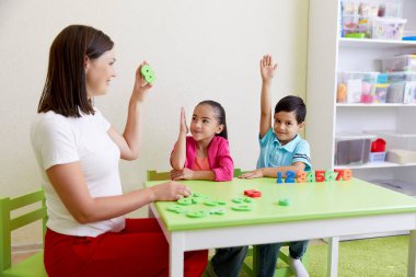 Children practice correct pronunciation with speech therapist