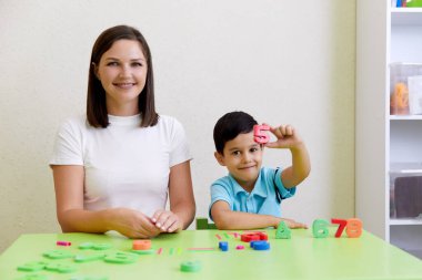 Children practice correct pronunciation with speech therapist