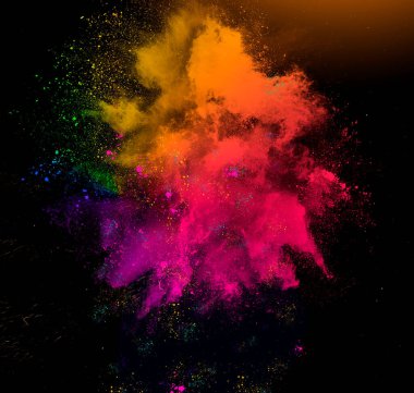 Colorful rainbow holi paint powder explosion isolated on black
