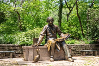 Bronze Statue reading book to a duck in the Central Park in New York