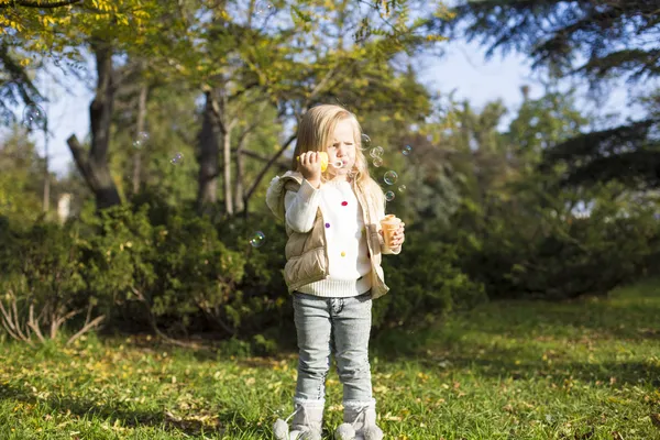 Funny little girl with soap bubbles — Stock Photo, Image