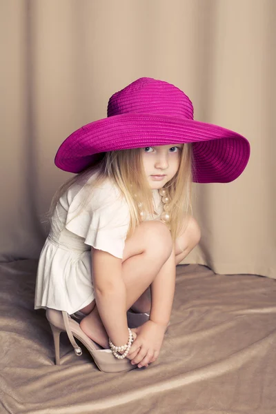 Funny little girl wearing mummy's shoes — Stock Photo, Image