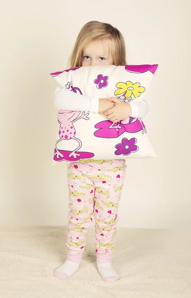 Cute little girl holding pillow — Stock Photo, Image