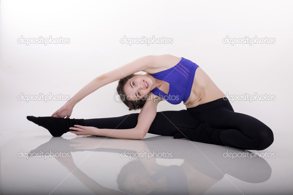 beautiful woman making stretching at white studio