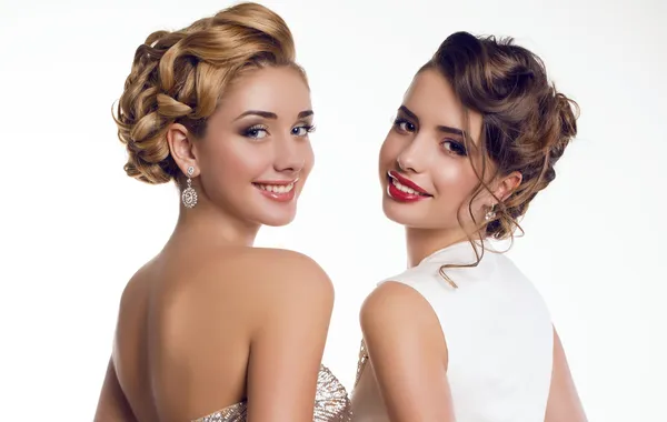 Two beautiful young girls in elegant dresses — Stock Photo, Image