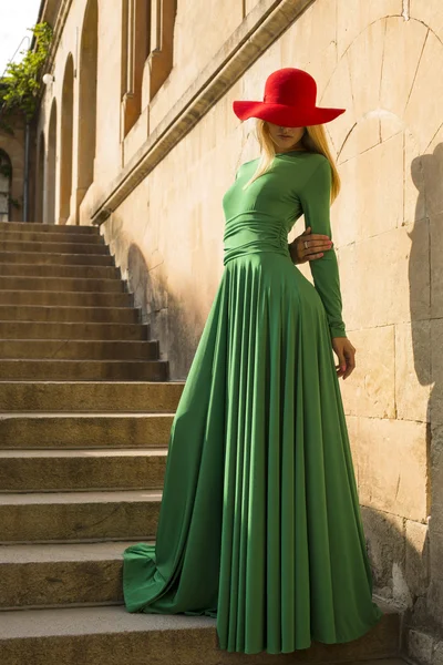 Beautiful woman with blond hair in elegant dress posing at summer park — Stock Photo, Image