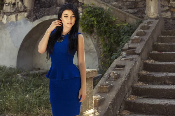 Beautiful girl with dark hair in elegant blue dress — Stock Photo, Image