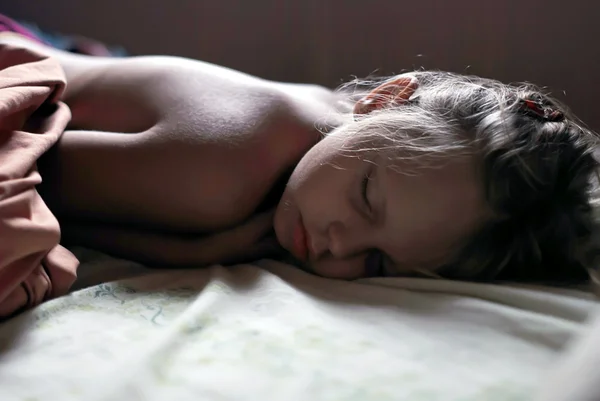 Klein meisje slaapt goed in haar bed — Stockfoto