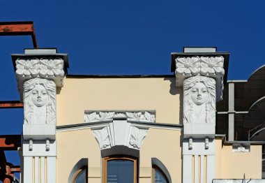 Kyiv Ukrayna 'daki eski bina cephesinde iki kadın maskarası.