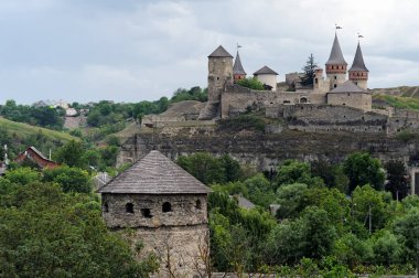 Old tower at background with Kamianets-Podilskyi Castle on background, Kamianets-Podilskyi, Ukraine