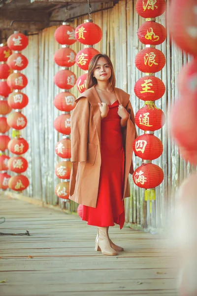 中国の旧正月旅行で清サム伝統的な赤いドレスを着て美しいアジアの中国人女性川でボートに投稿 — ストック写真