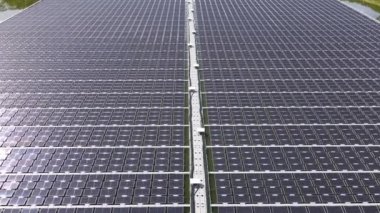 Aerial top view of solar panels or solar cells on buoy floating. Power plant with water, renewable energy source. Eco technology for electric power in industry. Alternative renewable energy.