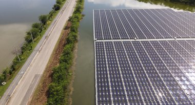 Aerial top view of solar panels or solar cells on buoy floating. Power plant with water, renewable energy source. Eco technology for electric power in industry. Alternative renewable energy.