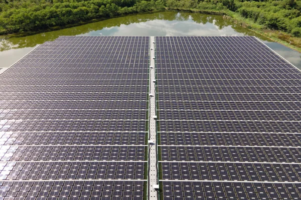 Aerial top view of solar panels or solar cells on buoy floating. Power plant with water, renewable energy source. Eco technology for electric power in industry. Alternative renewable energy.