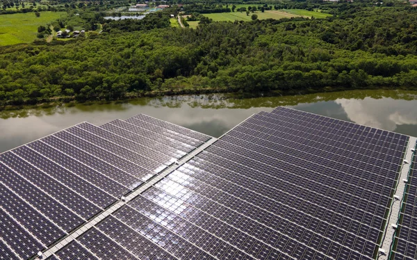 Aerial top view of solar panels or solar cells on buoy floating. Power plant with water, renewable energy source. Eco technology for electric power in industry. Alternative renewable energy.