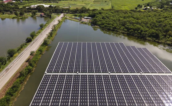 Aerial top view of solar panels or solar cells on buoy floating. Power plant with water, renewable energy source. Eco technology for electric power in industry. Alternative renewable energy.