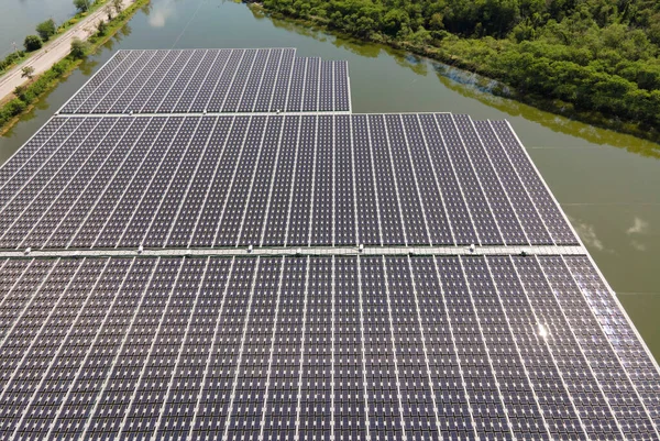 Aerial top view of solar panels or solar cells on buoy floating. Power plant with water, renewable energy source. Eco technology for electric power in industry. Alternative renewable energy.