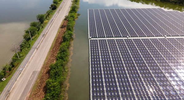 Aerial top view of solar panels or solar cells on buoy floating. Power plant with water, renewable energy source. Eco technology for electric power in industry. Alternative renewable energy.