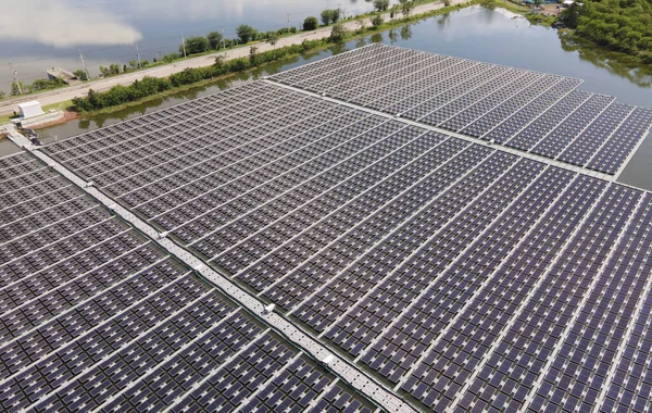 Aerial top view of solar panels or solar cells on buoy floating. Power plant with water, renewable energy source. Eco technology for electric power in industry. Alternative renewable energy.