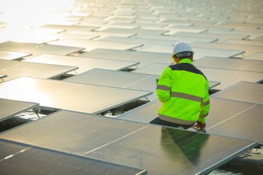 Portrait of professional man engineer working checking the panels at solar energy on buoy floating. Power plant with water, renewable energy source. Eco technology for electric power in industry.
