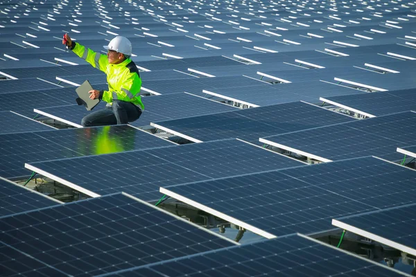 Portrait of professional man engineer working checking the panels at solar energy on buoy floating. Power plant with water, renewable energy source. Eco technology for electric power in industry.