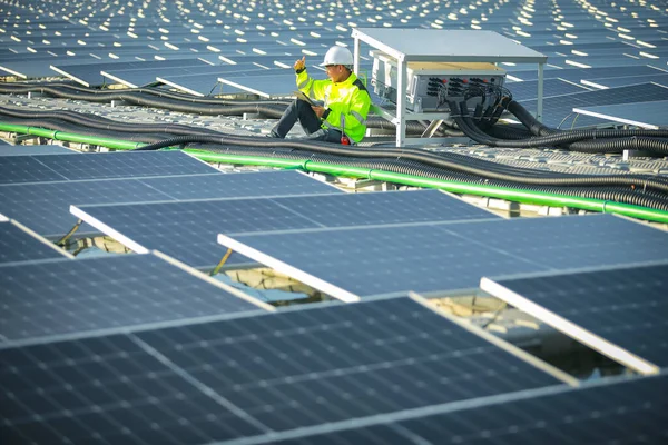 Portrait of professional man engineer working checking the panels at solar energy on buoy floating. Power plant with water, renewable energy source. Eco technology for electric power in industry.