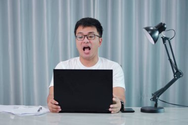 teknoloji, uzaktan iş ve yaşam tarzı konsepti - gözlüklü mutlu Asyalı adam evde veya online alışveriş, ev işi, serbest çalışma, çevrimiçi öğrenme, öğrenim.