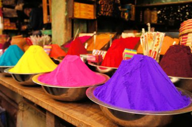 Bowls of vibrant colored dyes in India clipart