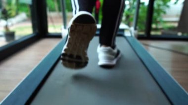 view of female running on the running track, slow motion