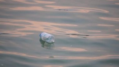 close-up footage of plastic bottle floating in sea