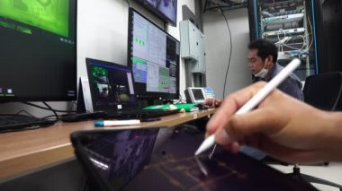 Elektrik kontrol odasında çalışan iki mühendis.