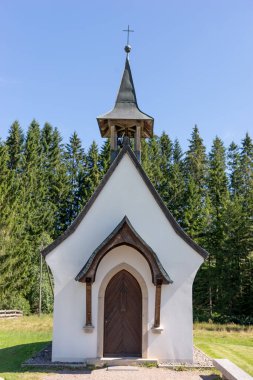 Small white chapel in front of the forest edge in the Black Forest. Germany