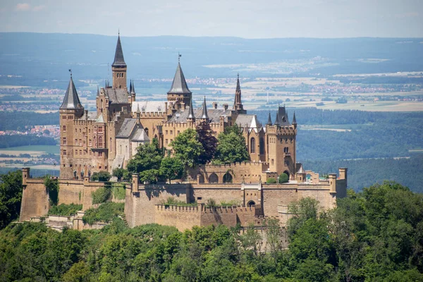Hohenzollern Castle on mountain top. Germany. Famous landmark in vicinity of Stuttgart. Scenic view of Burg Hohenzollern in summer