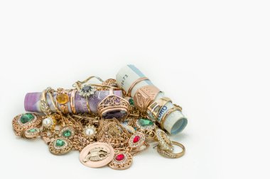 Pile of gold jewelry on white background