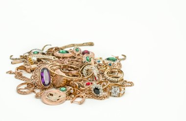 Pile of gold jewelry on white background