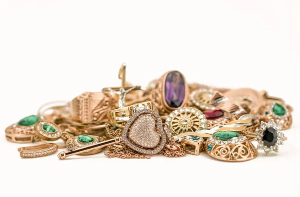 Pile of gold jewelry on white background