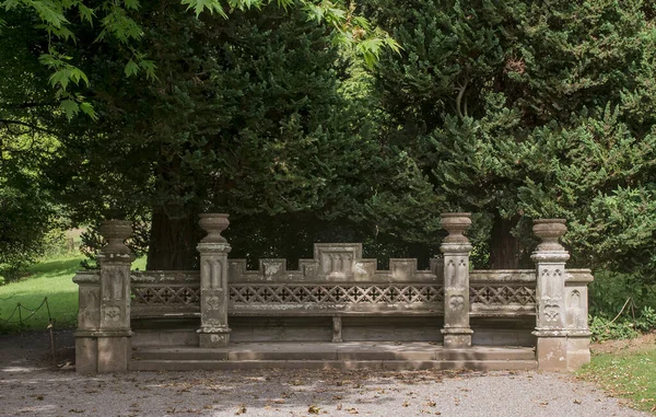 A concrete bench in a park