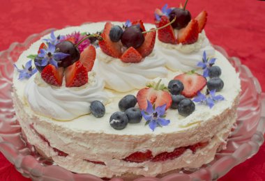 Creamy mascarpone cheese cake with strawberry and edible flowers