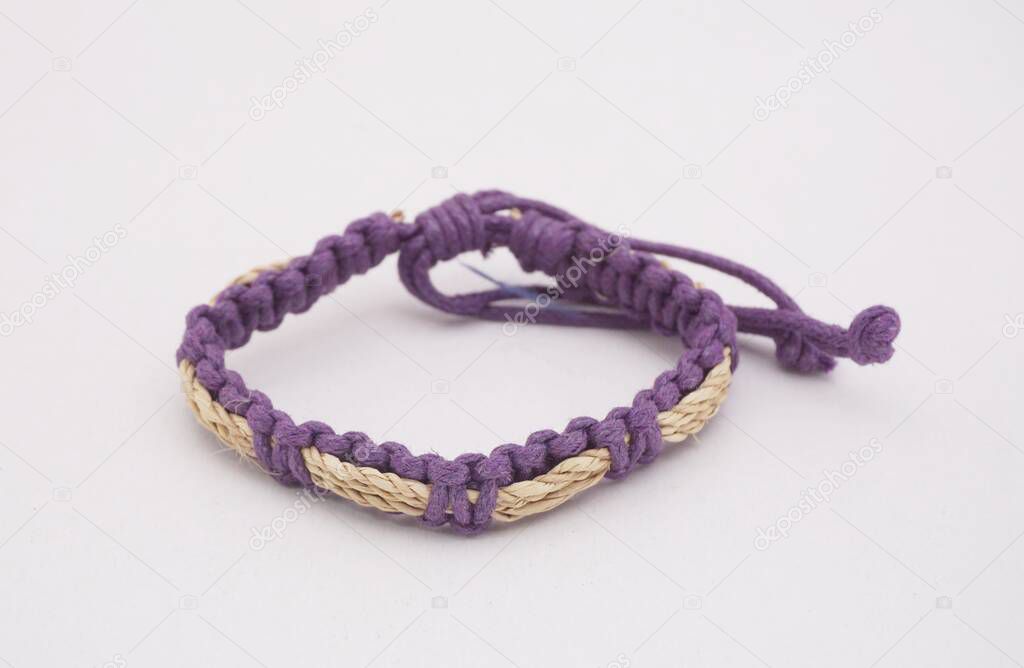 An isolated ethnic bracelet on white background. The bracelet is made off the various rope