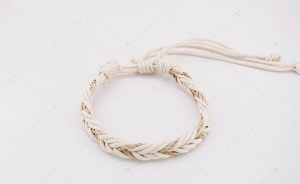 An isolated ethnic bracelet on white background. The bracelet is made off the various rope