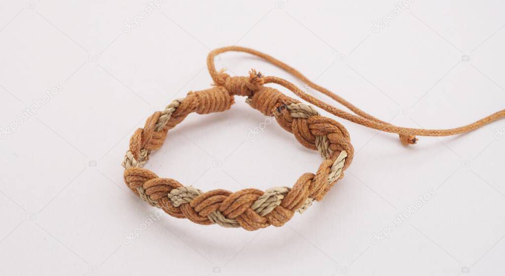 An isolated ethnic bracelet on white background. The bracelet is made off the various rope