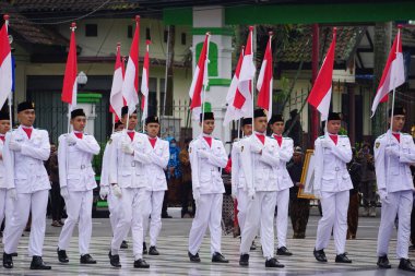 Paskibraka (Indonesian flag raiser) with national flag during grebeg pancasila